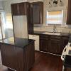 Kitchen.  Includes microwave, dishwasher, oven/stove combo, center island, access to backyard, and access to basement